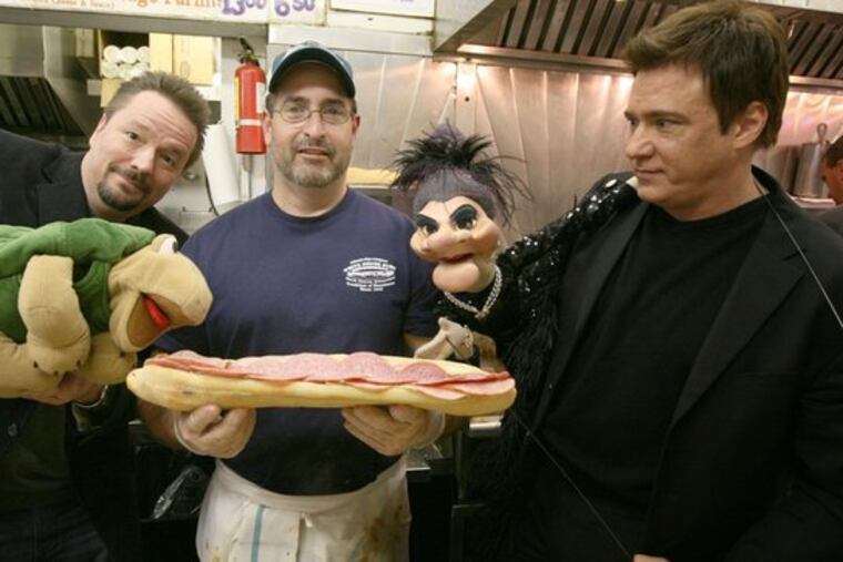 A mouthful - or a handful? In Atlantic City for gigs, Terry Fator (animating Winston) and Rick Skye (resuscitating Madame) visit the White House Sub Shop. Sandwiched between them yesterday was employee Ralph Pileggi.