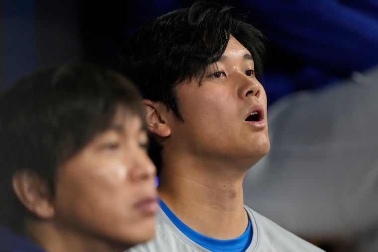 Shohei Ohtani (right) and his interpreter, Ippei Mizuhara, in the season opener on Wednesday.