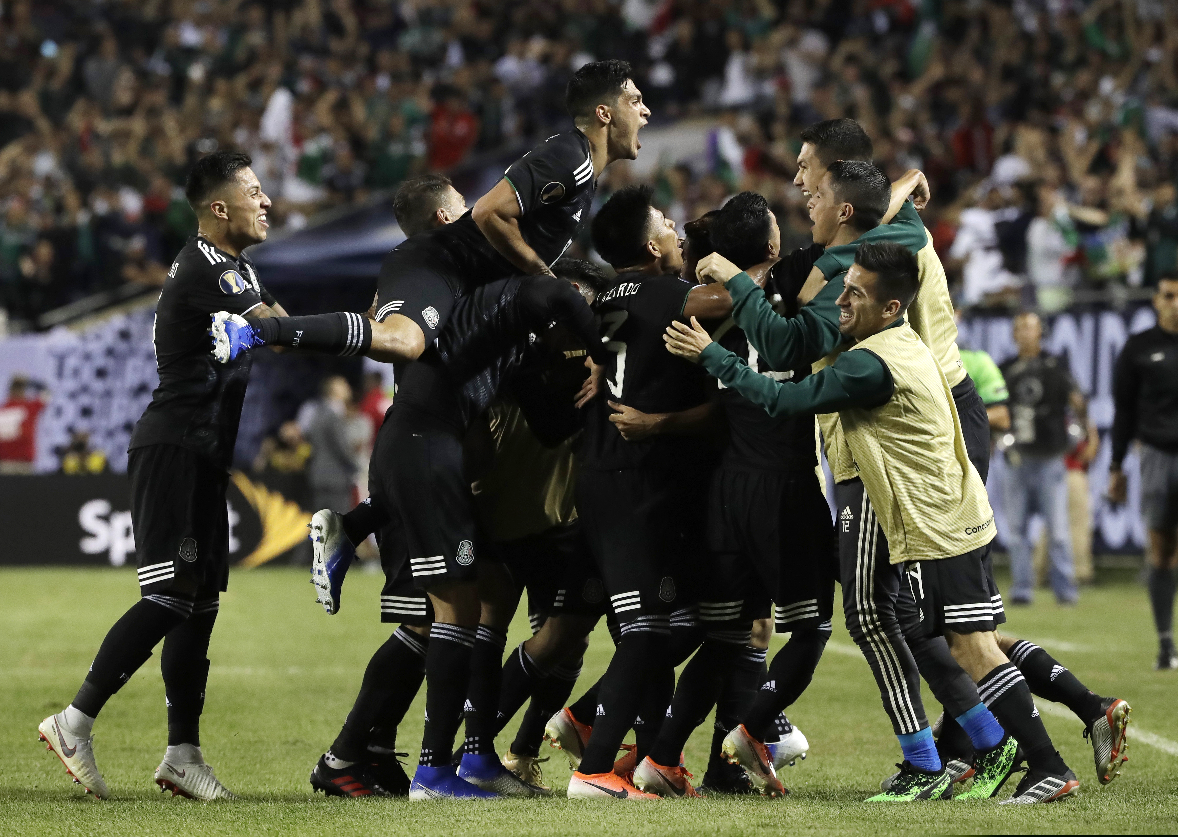 Mexico's Jonathan Dos Santos celebrates with teammates after scoring his first goal against the U.S. during the second half on Sunday.