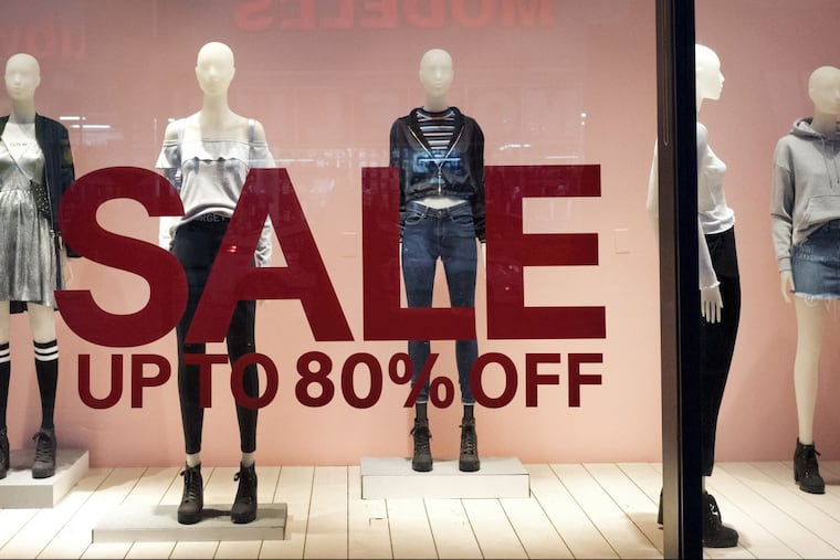 An H& M store window advertises a sale, in New York. Store sales have slowed and forced the company to change its strategy.