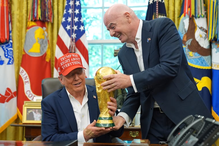 FIFA president Gianni Infantino (right) giving the men's World Cup trophy to President Donald Trump last year at the White House.