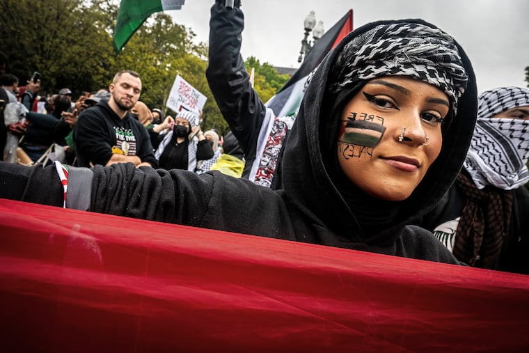 A woman wears her message on her cheek as hundreds gather in front of the White House Oct. 14 to protest the retaliatory actions of Israel in Gaza.