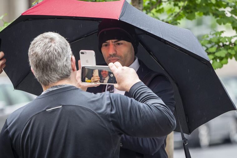 Lawyer Aaron Schlossberg (center), the man who ranted against people speaking Spanish in a Midtown restaurant, takes a cellphone video of reporters as he leaves his home in Manhattan, New York, on Thursday, May 17, 2018.