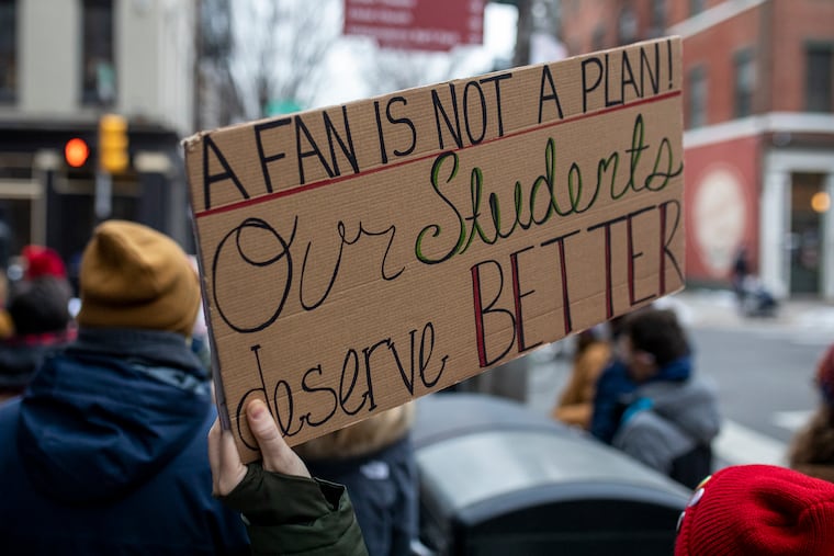 Philadelphia Educators stand outside Mayor Kenney’s residence at 3rd and Race Street to protest COVID-19 risks inside schools along with other hazardous problems before the pandemic on Friday, Feb. 12, 2021.