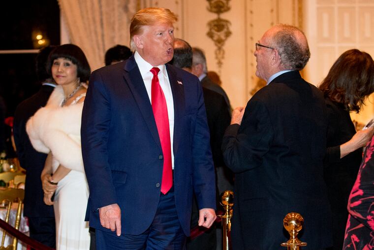 President Donald Trump speaks to attorney Alan Dershowitz, right, as he arrives for Christmas Eve dinner at Mar-a-lago in Palm Beach, Fla., Tuesday, Dec. 24, 2019.
