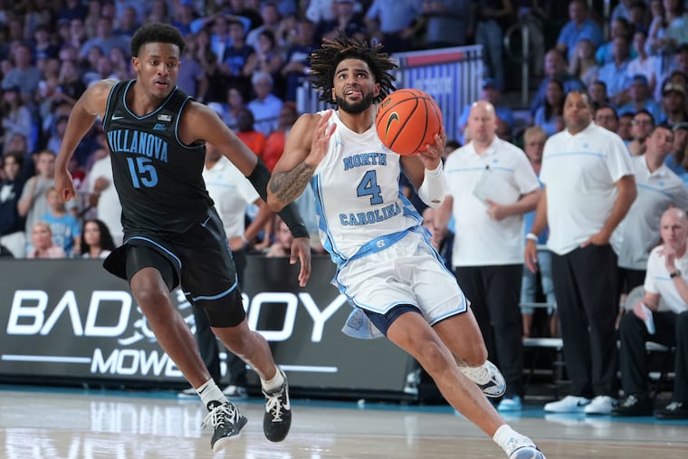 Villanova's Jordan Longino (left) chases down North Carolina's RJ Davis in overtime in the Battle 4 Atlantis on Thanksgiving.