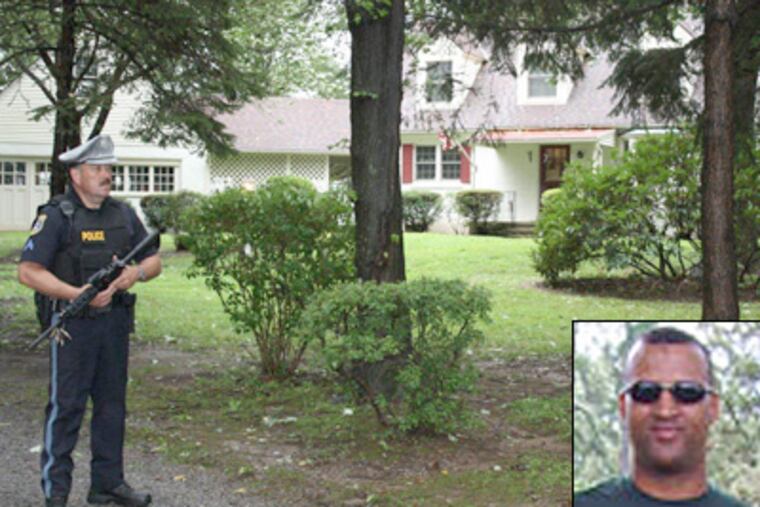 A police officer stands guard Sunday outside the Buckingham Township home of Barbara Ruehl, 66, who was shot to death in her easy chair. The body of Army Capt. Leonard John Egland (inset) was found Sunday. Egland was suspected of murdering four. (Larry King / Staff)