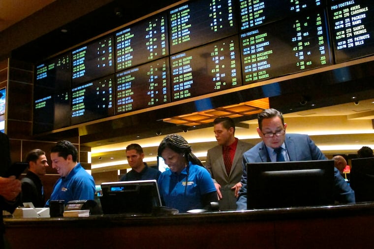 FILE - In this Oct. 25, 2018, file photo, employees prepare to take bets moments before the new sports book at the Tropicana casino in Atlantic City, N.J., opened. Most of the states that moved quickly to legalize sports betting after a Supreme Court decision last year are still waiting for the expected payoff. Only New Jersey and Delaware saw the tax revenue to their state budgets meet projections. (AP Photo/Wayne Parry, File)