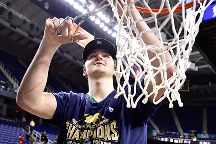 Notre Dame Fighting Irish guard Steve Vasturia (32) helps cut down the net. The Fighting Irish defeated the North Carolina Tar Heels 90-82 in the championship game of the ACC Tournament at Greensboro Coliseum. (Bob Donnan/USA Today)