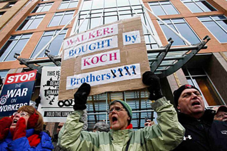 Union supporters demonstrate in front of Koch Industries HQ in Madison, Wisc., last week. (Associated Press)