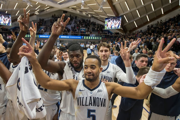 Eric Paschall, Phil Booth, and Tim Delaney of Villanova greet the student section after their victory over Providence on Wednesday.
