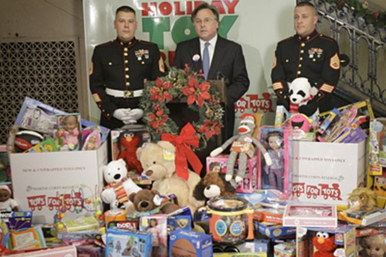 CEO of Philadelphia Newspapers Brian Tierney, center, announces it's Holiday Toy Rush to benefit the Toys For Tots toy drive on November 12, 2009. He is pictured with U.S. Marine Corps Reserves Gunner Sgt. David Pierson, left, and Staff Sgt. Elliott Miller, right. ( David Maialetti / Staff Photographer )