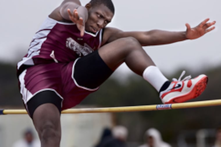 Bridgeton's Joseph Bunton scissor-kicks his way over the bar during his second try at 5 feet, 8 inches in the final rounds of the high jump at Bridgeton. He and Robert Robinson combined for first place.