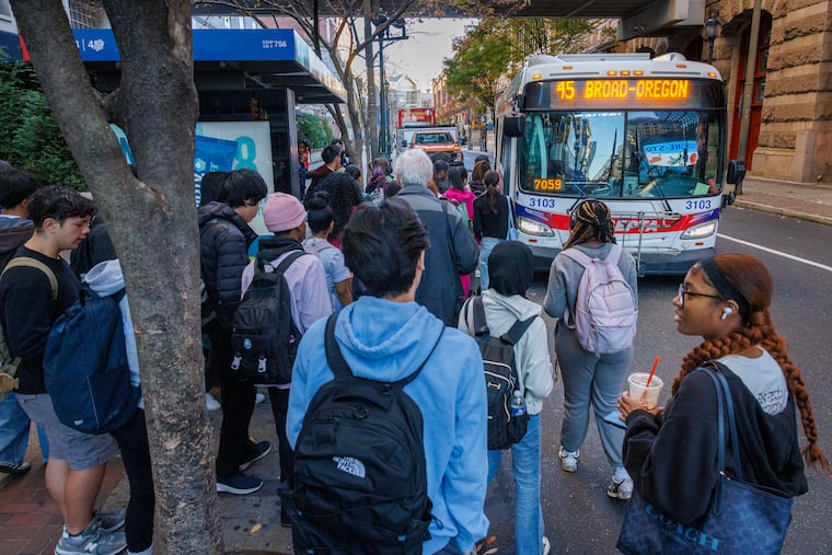 Students wait for the SEPTA 45 bus at the corner of 12th Street just above Market Street as they commute to school.