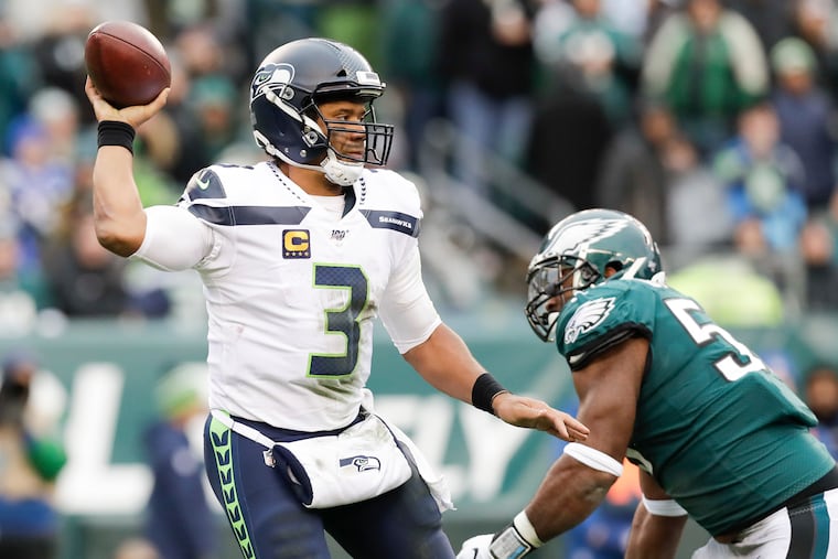 Seattle’s Russell Wilson passes as Brandon Graham moves in during the Eagles' ugly 17-9 loss on Nov. 24, in what was possibly Carson Wentz's worst loss as a pro.