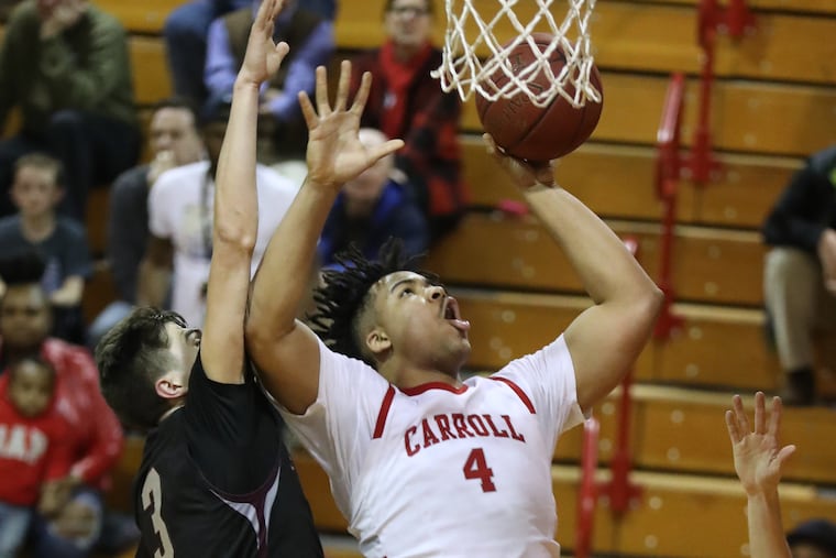 Tairi Ketner (right) of Archbishop Carroll goes up for a shot against Chris Arizin of St. Joseph’s Prep.
