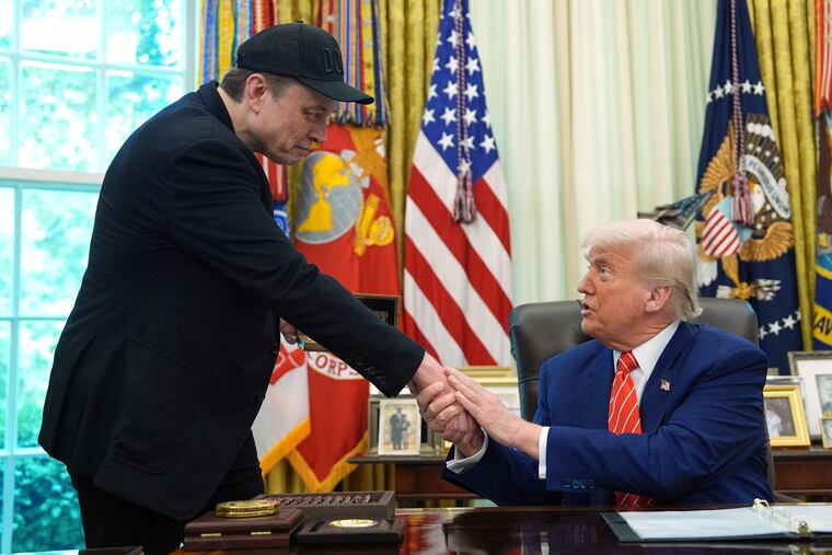 President Donald Trump, right, shakes the hand of Elon Musk during a news conference in the Oval Office of the White House, Friday, May 30, 2025, in Washington.