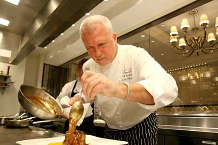 Martin Hamann, a Four Seasons alumnus, finishes pork shank. (Charles Fox / Staff Photographer)