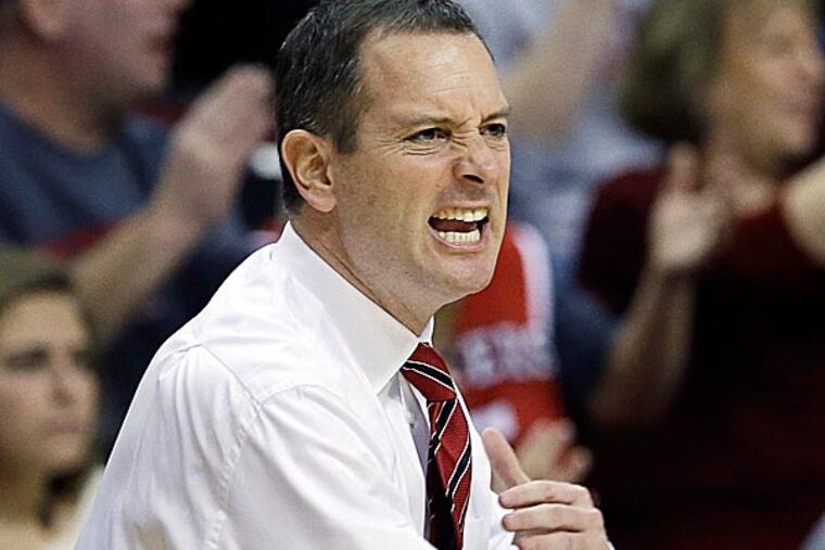 Rutgers said it would reconsider its decision to retain men's basketball coach Mike Rice after a videotape was televised showing him abusing players. (Mel Evans/AP)