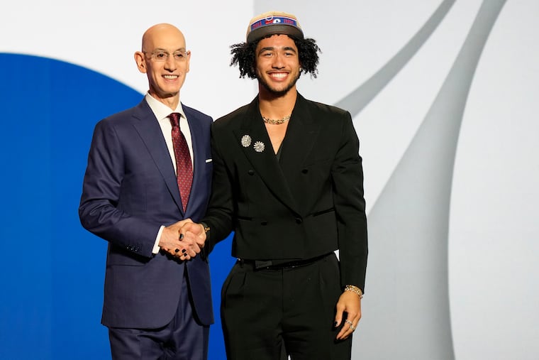 Jared McCain poses for a photo with NBA commissioner Adam Silver after being selected 16th by the Philadelphia 76ers during the first round of the NBA basketball draft, Wednesday, June 26, 2024, in New York.