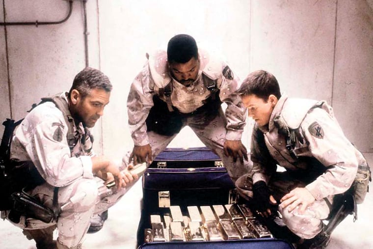 From left, actors George Clooney, Ice Cube and Mark Wahlberg scheme to steal Saddam Hussein's plundered gold in Warner Bros.' Gulf War action film, "Three Kings." (AP Photo/Warner Bros., Murray Close)