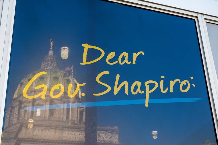 The 1906 Beaux Arts Capitol building in Harrisburg is reflected in the windows of an office building on North Third Street on Dec. 13, 2023.