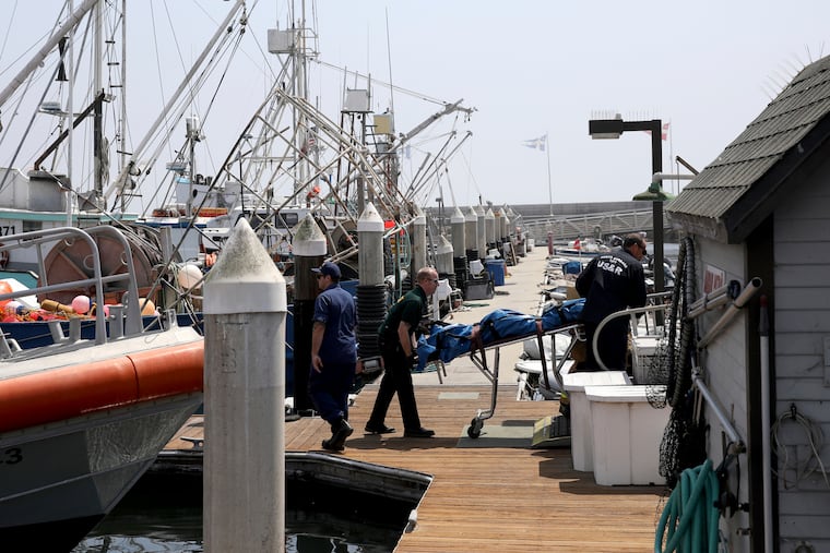 On the dock at Santa Barbara Harbor in California, search and rescue and sheriff's officers move a body recovered near a dive boat fire near Santa Cruz Island early Monday, Sept. 2.