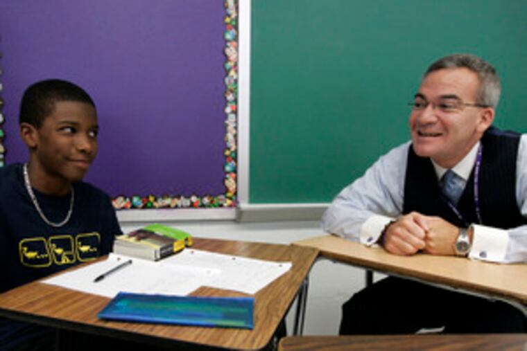 Joseph Meloche, principal of Cherry Hill West, talks to student Julian Bond during Bond's ninth-grade English class. "I can't wait for the discussion" of next summer's list, Meloche said.