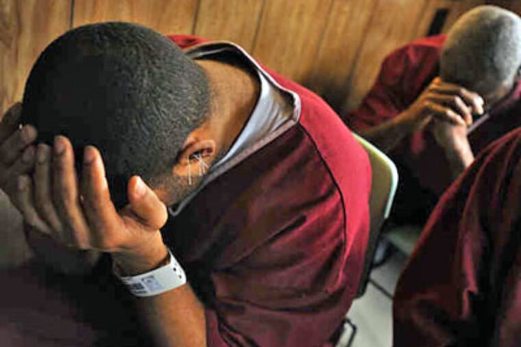 Inmates sit quietly after an acupuncturist has placed superfine stainless-steel needles in the outer ear. Nonviolent offenders are often sentenced to the rigorous 45-day program. (Amy Davis / Baltimore Sun)