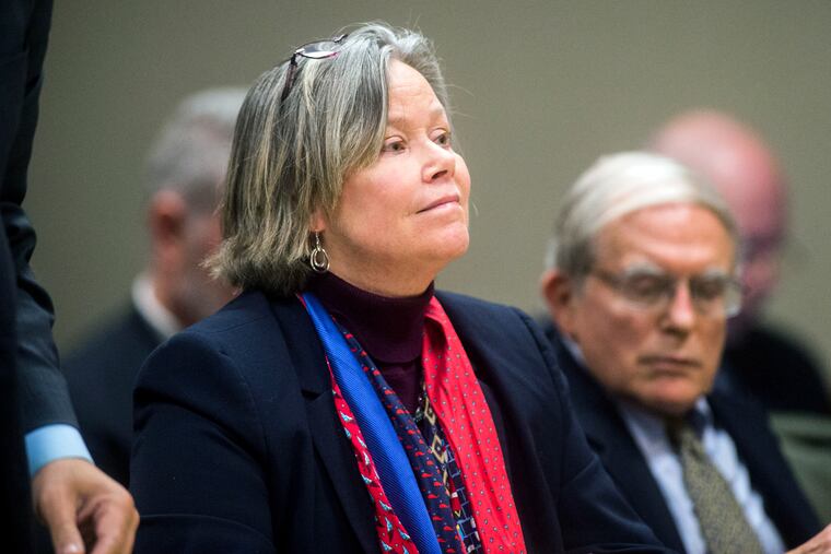 Dr. Eden Wells listens as Genesee District Judge William Crawford reads through a prepared statement during a hearing Friday, Dec. 7, 2018, at Genesee District Court in downtown Flint, Mich. Wells, Michigan's chief medical executive, will stand trial on involuntary manslaughter and other charges in a criminal investigation of the Flint water crisis, a judge ruled Friday.