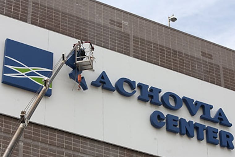 Workers begin removing the Wachovia Center logo. (Ed Hille/Staff Photographer)