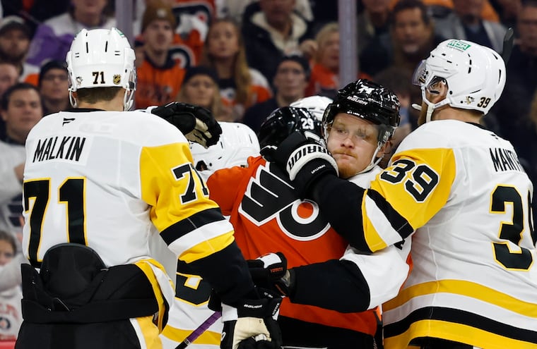 Flyers right wing Owen Tippett battles with Pittsburgh Penguins right wing Anthony Mantha and teammate center Evgeni Malkin during a game earlier this season.