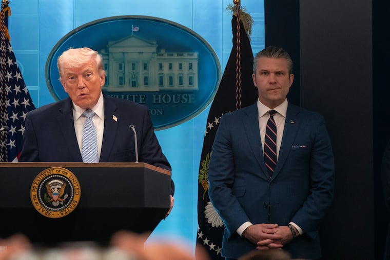 President Donald Trump speaks to reporters at a briefing last month, alongside Defense Secretary Pete Hegseth.