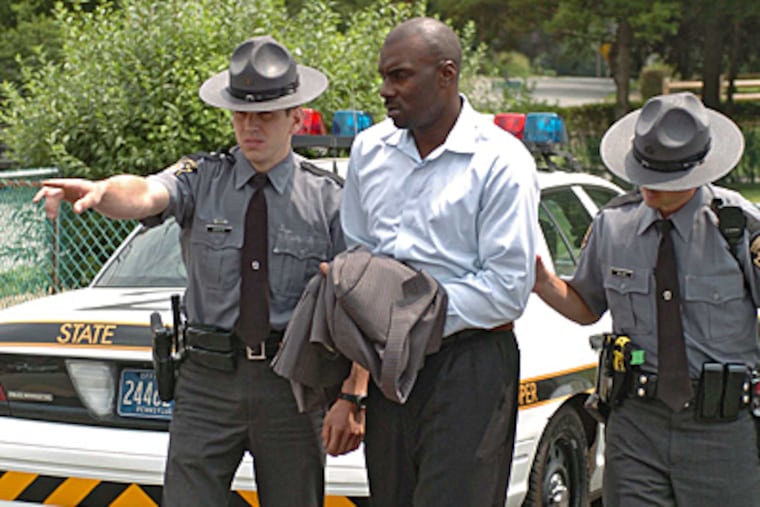 File photo of former Philadelphia Sixers player Aaron McKie being led into Montgomery County District Court to face gun-related charges. (Clem Murray / Inquirer)