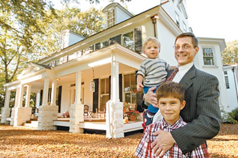 James Kozachek stands outside his 1700s Burlington County house with sons Andrew Cosolaro, 8,and Peter, 11/2. He was a bachelor when he bought the house in 2001 and began restoration work. (Michael Bryant / Staff Photographer)