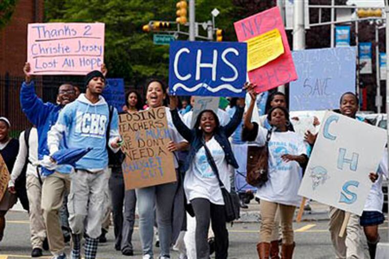 Cental High School students hold signs as they march to administrative offices in Newark, N.J., at about 11 a.m., Tuesday, after walking out of classes. Similar protests were simultaneously throughout the state. (AP Photo / Mel Evans)