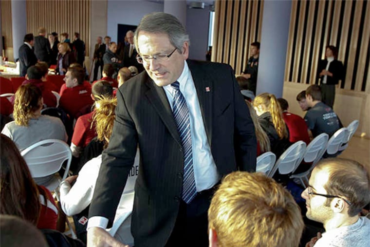 Theobald shaking hands with student athletes who had gathered in December 2013 in opposition to cuts in sports programs. "I'd rather hang myself before I do that again," he said of cutbacks.