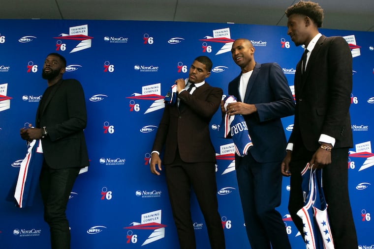 From left, James Ennis, Tobias Harris, Al Horford, and Josh Richardson walk off after posing for phots with their jerseys after an introductory press conference introducing both new and resigned players at the Philadelphia 76ers Training Complex in Camden, NJ on Friday, July 12, 2019.