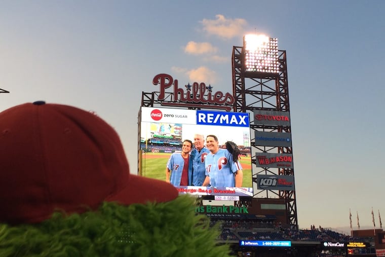 With the Phillie Phanatic looking on, Phillies legend Mike Schmidt (center) with actor Troy Gentile (left), who plays Barry Goldberg on ABC's "The Goldbergs," and the real Barry Goldberg, whose brother Adam is the show's creator, pose together at Citizens Bank Park on Sept. 15, 2017. This event, in which Schmidt surprised Goldberg and fans by showing up to catch as Barry Goldberg threw out the first pitch, inspired the May 2 episode of “The Goldbergs”