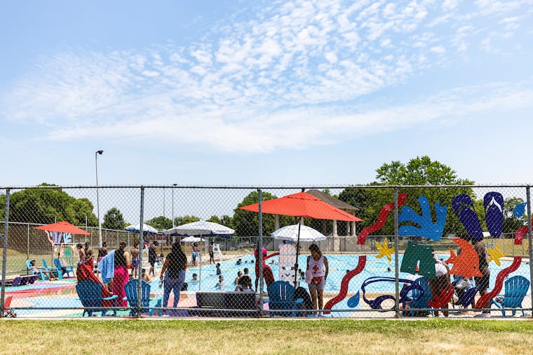 Families out enjoying an oasis from the urban heat at at Hunting Park Pool on Tuesday, when the temperature hit 90 to kick off the first heat wave of the year.