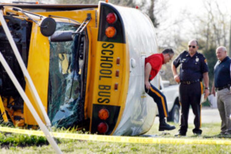 Woolwich Township police investigate the bus crash at Oldmans Creek and Rainey Roads. The high school students were returning from the Salem County Vocational Technical School.