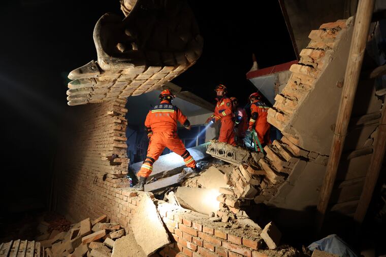 Rescuers work on the rubble of a house that collapsed in the earthquake in Kangdiao village of Jishishan county in northwestern China's Gansu province on Tuesday, Dec. 19, 2023.