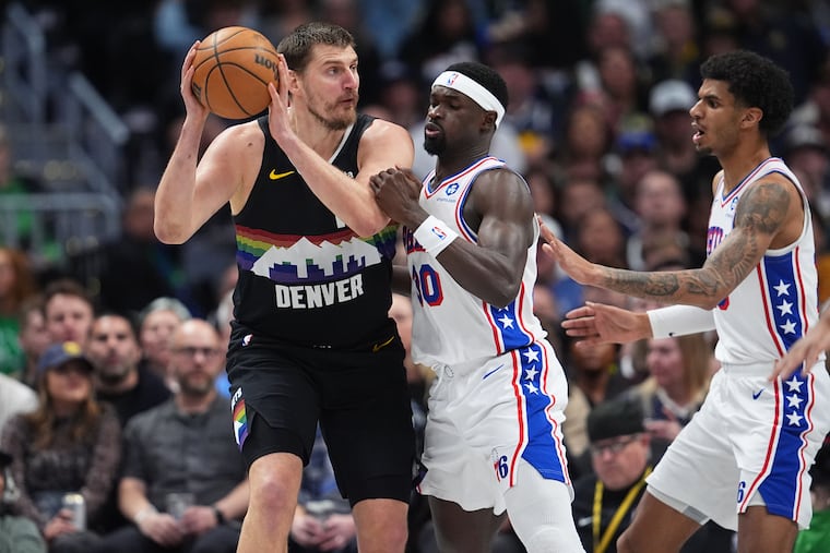 Denver Nuggets center Nikola Jokić (left) scored eight points on 4 of 7 shooting but reached 10 assists in less than 12 minutes.