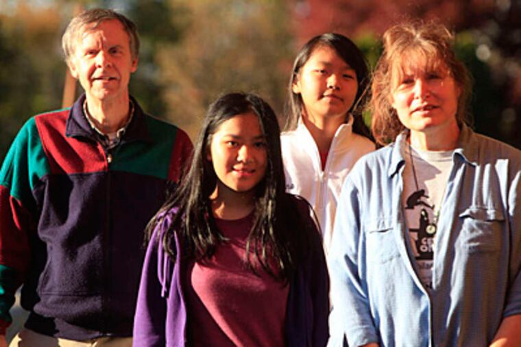 Susan and David Morgan with their daughters Anna (left), 14, and Mary Ruth, 13, both adopted from China. Last summer, Susan and Anna traveled from Ambler to Jiangxi province seeking answers about the girls' Chinese parents. (DAVID SWANSON / Staff Photographer)