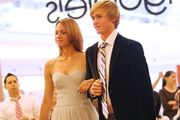 A couple models prom fashions in Orlando, Fla. Experts say teens interest in romantic love can vary greatly from child to child. (Sara A. Fajardo//MCT)