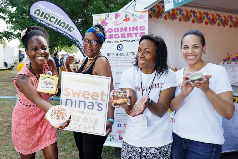 Marian Dossou of KakeMi Cakes (left), Nina Bryan of Sweet Nina’s (center), and mother-daughter Carol Blacken and Jillian Blacken of Jillian’s Bakes, who work out of the Enterprise Center in West Philadelphia, are selling their wares at the Philadelphia Flower Show.