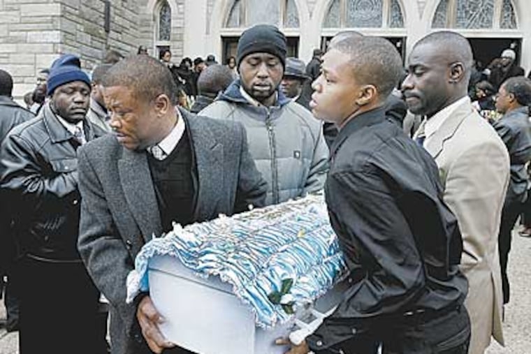 Pallbearers are bringing out Zyhire Wright-Teah's casket after the funeral service at the Divine Mercy Parish in West Philly on Saturday. (Akira Suwa / Staff Photographer ).