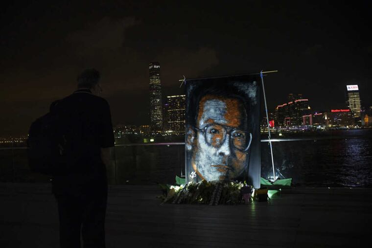 A man pays tribute to late Chinese Nobel Peace laureate Liu Xiaobo at a downtown park along Victoria Harbor in Hong Kong on Wednesday.