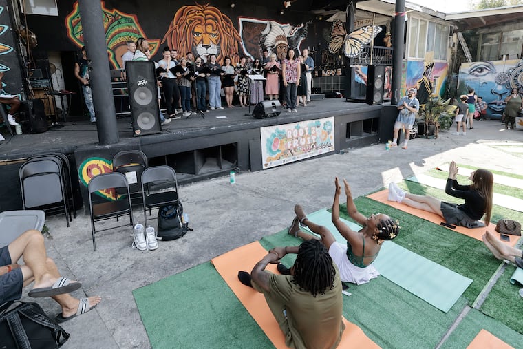 The crowd cheers for PhilHarmonia, the community chamber choir that just performed on stage, during the Root 2 Fruit Festival — a “creative wellness” day featuring music, dance, meditation, yoga, art, and more at the One Art Community Center in West Philadelphia on Sept. 14.