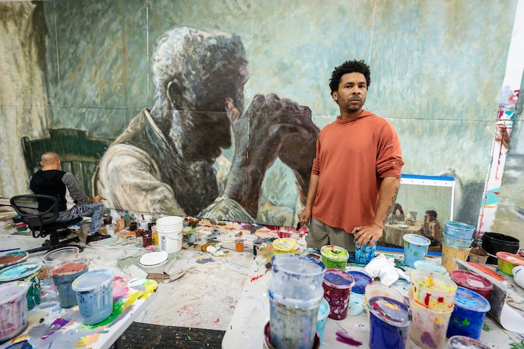 George Anthony Morton works on a mural that pays tribute to Henry Ossawa Tanner.